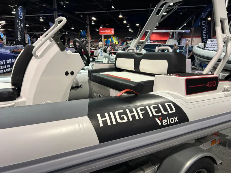 Slide: The Image of 2025 Highfield Velox 420 boat interior with black, white, and red seating. - 11