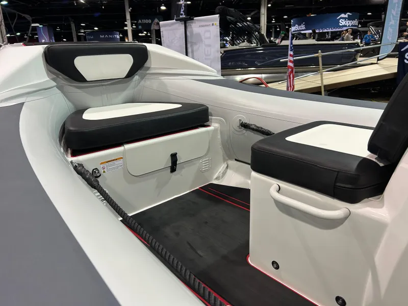Slide: The Image of 2025 Highfield Velox 420 boat interior with black and white seating at a boat show. - 15