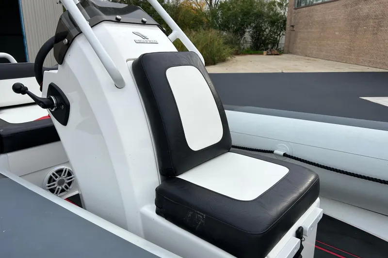 Slide: The Image of 2025 Highfield Velox 420 boat seat with black and white upholstery, outdoor setting. - 16