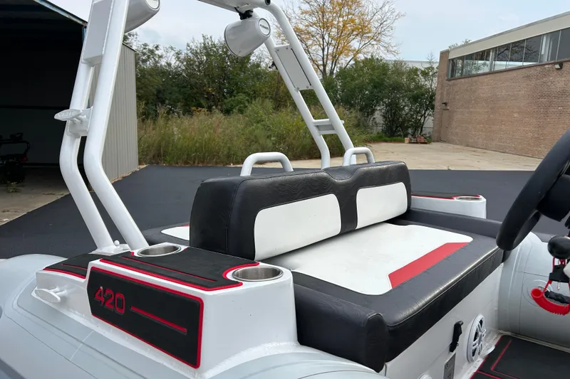 Slide: The Image of 2025 Highfield Velox 420 boat interior with black and white seating, outdoor setting. - 17