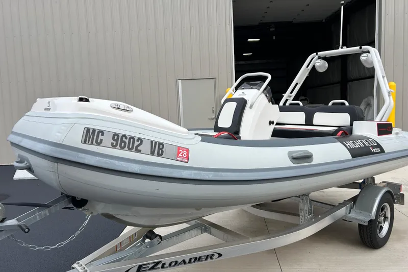 Slide: The Image of 2025 Highfield Velox 420 boat on trailer, parked outside a building. - 20