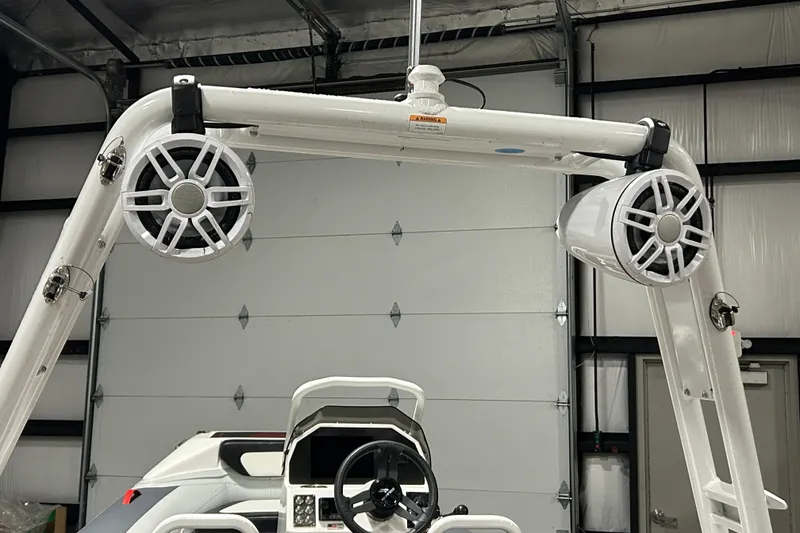 Slide: The Image of Highfield Velox 420 boat with mounted speakers, 2025 model, in a garage setting. - 23