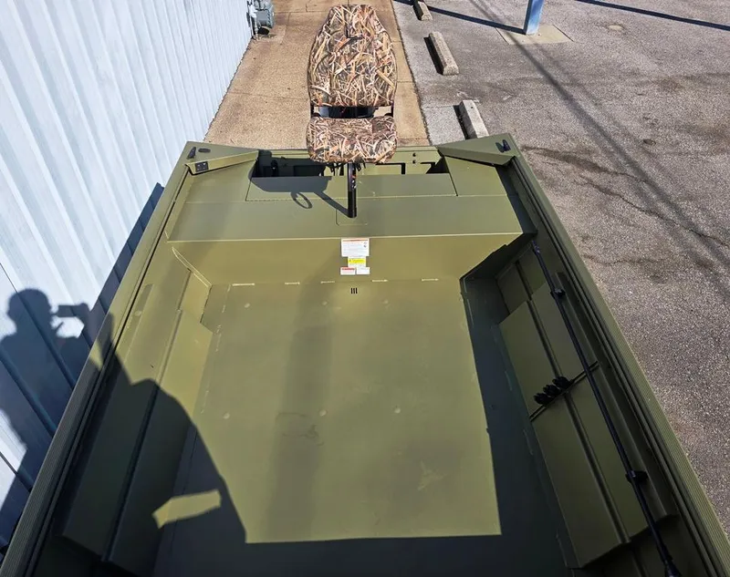 Slide: The Image of 2025 Lowe Roughneck RX1660 Tiller Steer boat with camouflage seat, parked outdoors. - 4