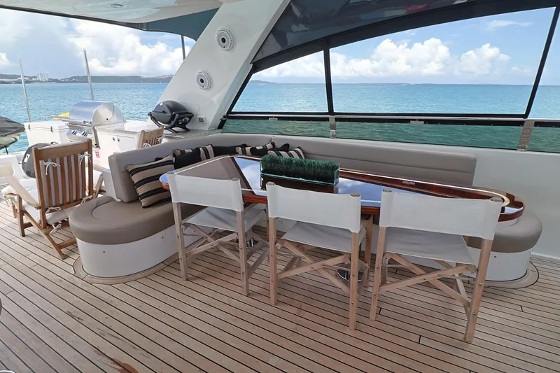 Slide: The Image of Luxurious 2013 Cheoy Lee Bravo yacht deck with seating, dining area, and ocean view. - 21