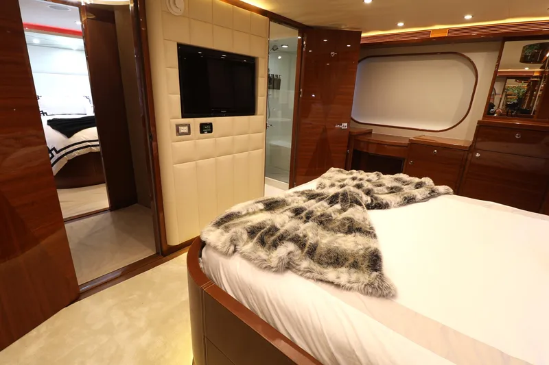 Slide: The Image of Luxurious Cheoy Lee Bravo 2013 yacht bedroom with elegant wood finishes and plush bedding. - 38