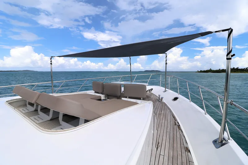 Slide: The Image of 2013 Cheoy Lee Bravo yacht deck with sunshade and lounge chairs on open water. - 8
