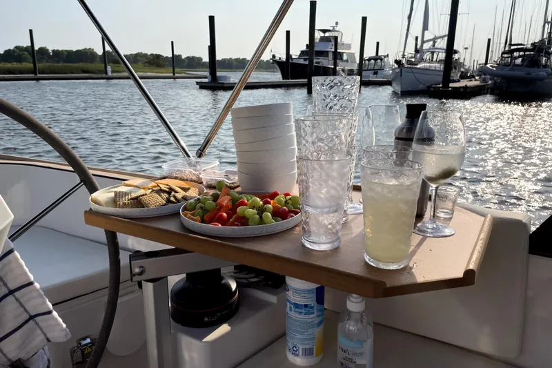 Slide: The Image of Snack and drink setup on a 2023 Saffier 8m Open yacht, docked at a marina. - 10