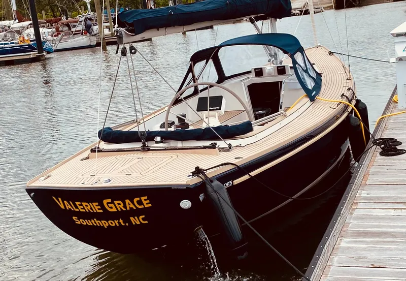 Slide: The Image of 2023 Saffier 8m Open sailboat docked, named "Valerie Grace," in Southport, NC marina. - 2