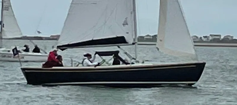 Slide: The Image of 2023 Saffier 8m Open sailboat on water with crew, overcast sky. - 7