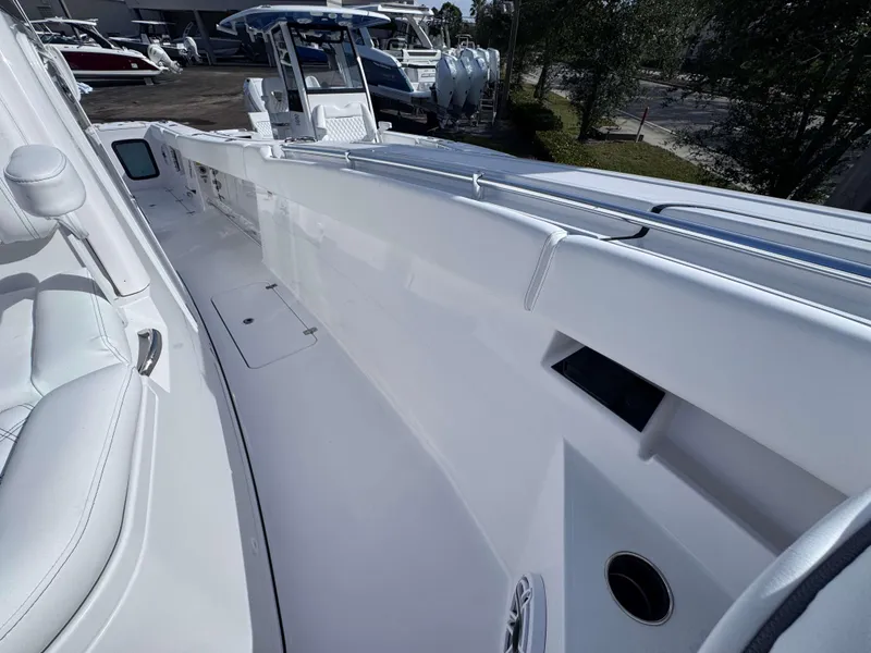 Slide: The Image of 2025 Sportsman 322 Open boat interior with sleek white design and seating. - 16
