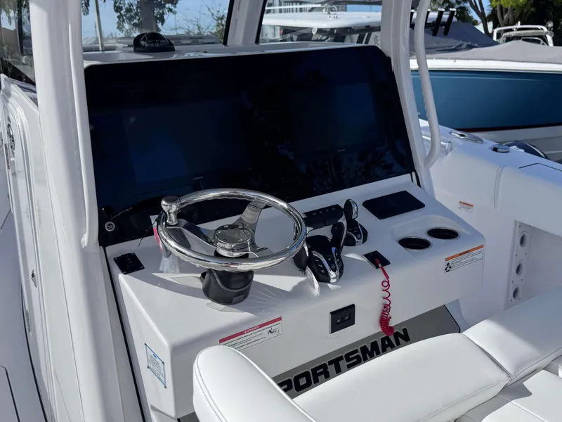 Slide: The Image of 2025 Sportsman 322 Open boat dashboard with steering wheel and controls. - 19