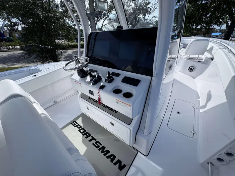 Slide: The Image of 2025 Sportsman 322 Open boat interior with steering console and seating. - 21