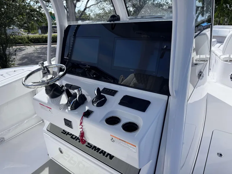 Slide: The Image of 2025 Sportsman 322 Open boat dashboard with steering wheel and controls. - 22