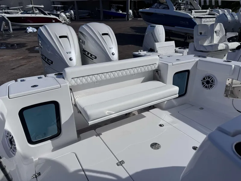 Slide: The Image of 2025 Sportsman 322 Open boat interior with dual engines and white seating. - 27