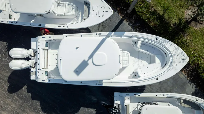 Slide: The Image of Aerial view of 2025 Sportsman 322 Open boat with dual engines, docked on pavement. - 3