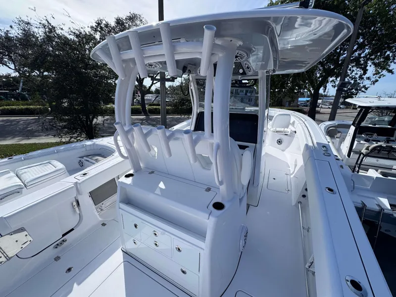 Slide: The Image of 2025 Sportsman 322 Open boat interior with rod holders and storage compartments. - 30