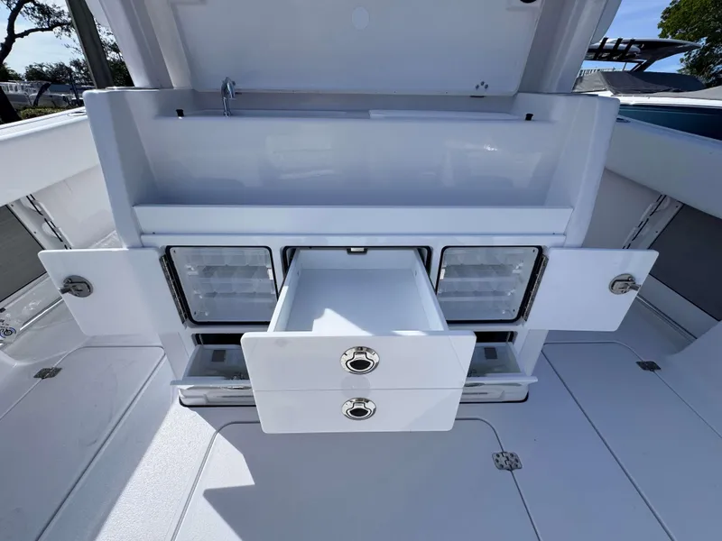 Slide: The Image of 2025 Sportsman 322 Open boat storage compartments with open drawers and cabinets. - 32