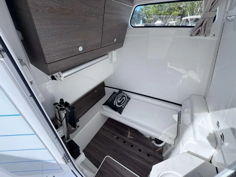 Slide: The Image of 2025 Sportsman 322 Open cabin interior with wood accents and seating. - 5