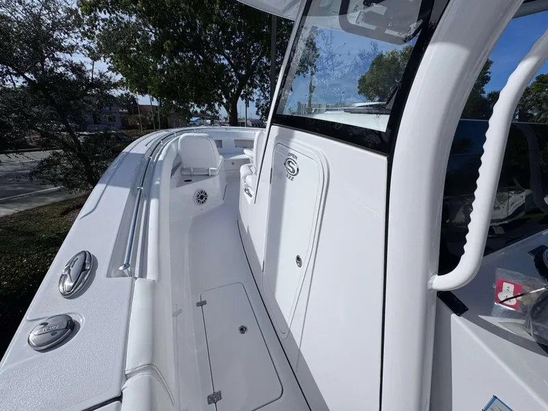 Slide: The Image of 2025 Sportsman 322 Open boat, sleek white design, spacious deck, modern features. - 6