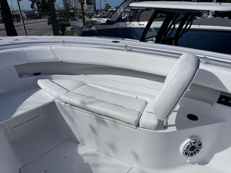 Slide: The Image of 2025 Sportsman 322 Open boat interior with white seating and speaker. - 7