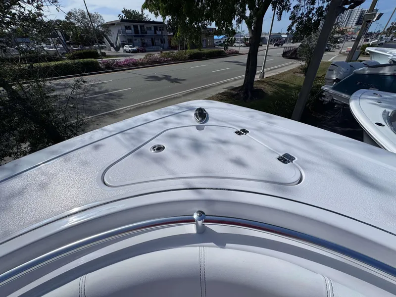 Slide: The Image of 2025 Sportsman 322 Open boat deck, parked near a road with trees and buildings. - 9