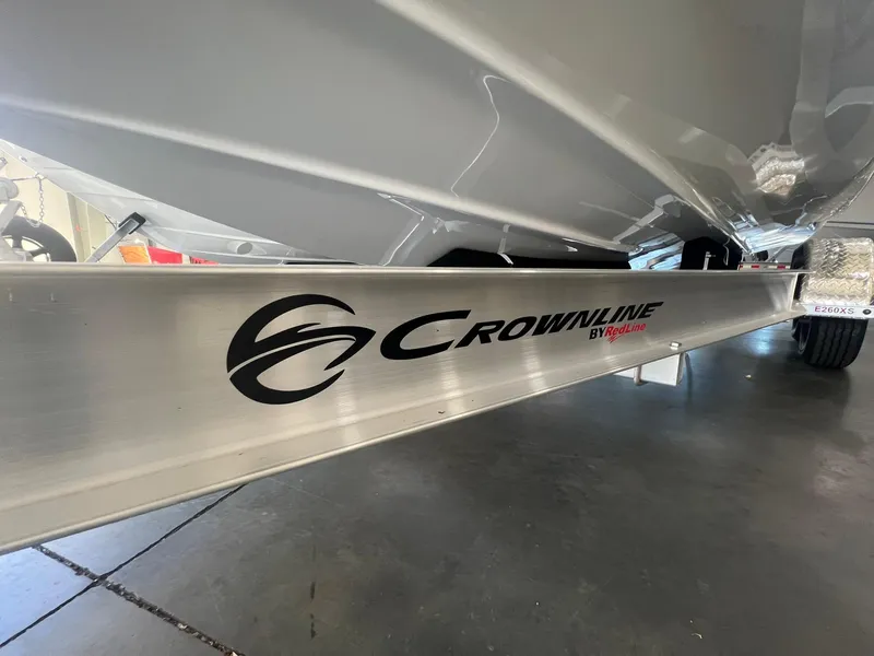 Slide: The Image of 2025 Crownline Eclipse E260 XS boat trailer close-up in showroom. - 1