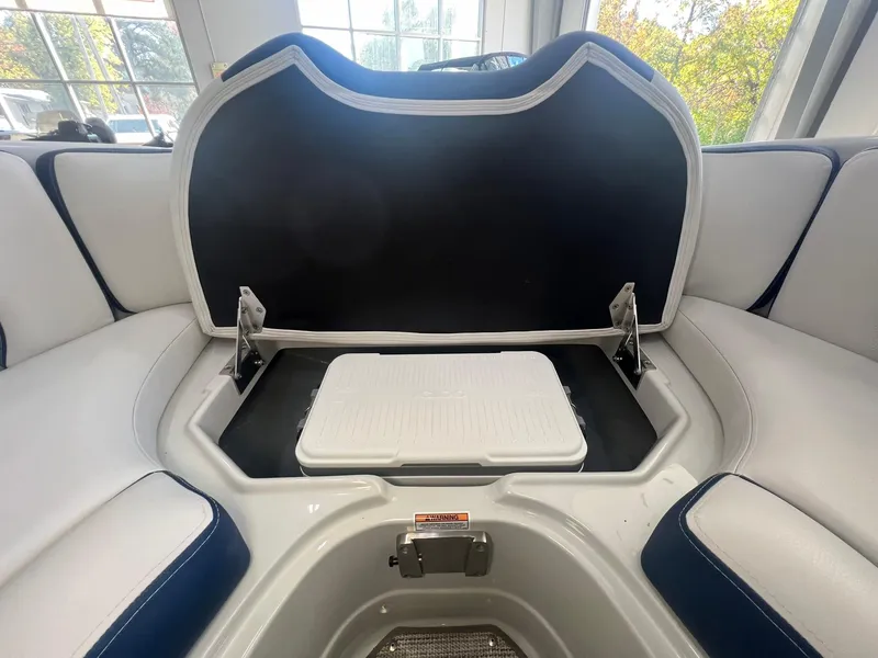 Slide: The Image of 2025 Crownline Eclipse E260 XS boat interior with open storage compartment. - 13