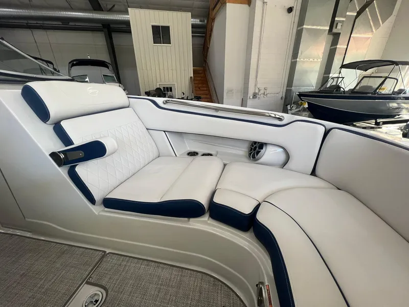 Slide: The Image of Luxurious seating in 2025 Crownline Eclipse E260 XS boat, featuring white and navy upholstery. - 15