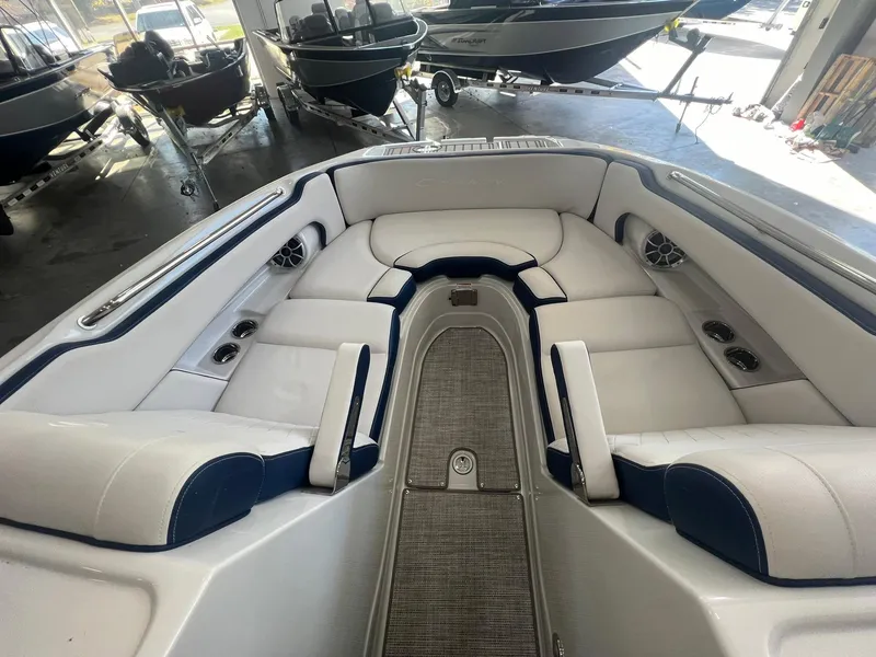 Slide: The Image of 2025 Crownline Eclipse E260 XS boat interior with plush seating and modern design. - 16