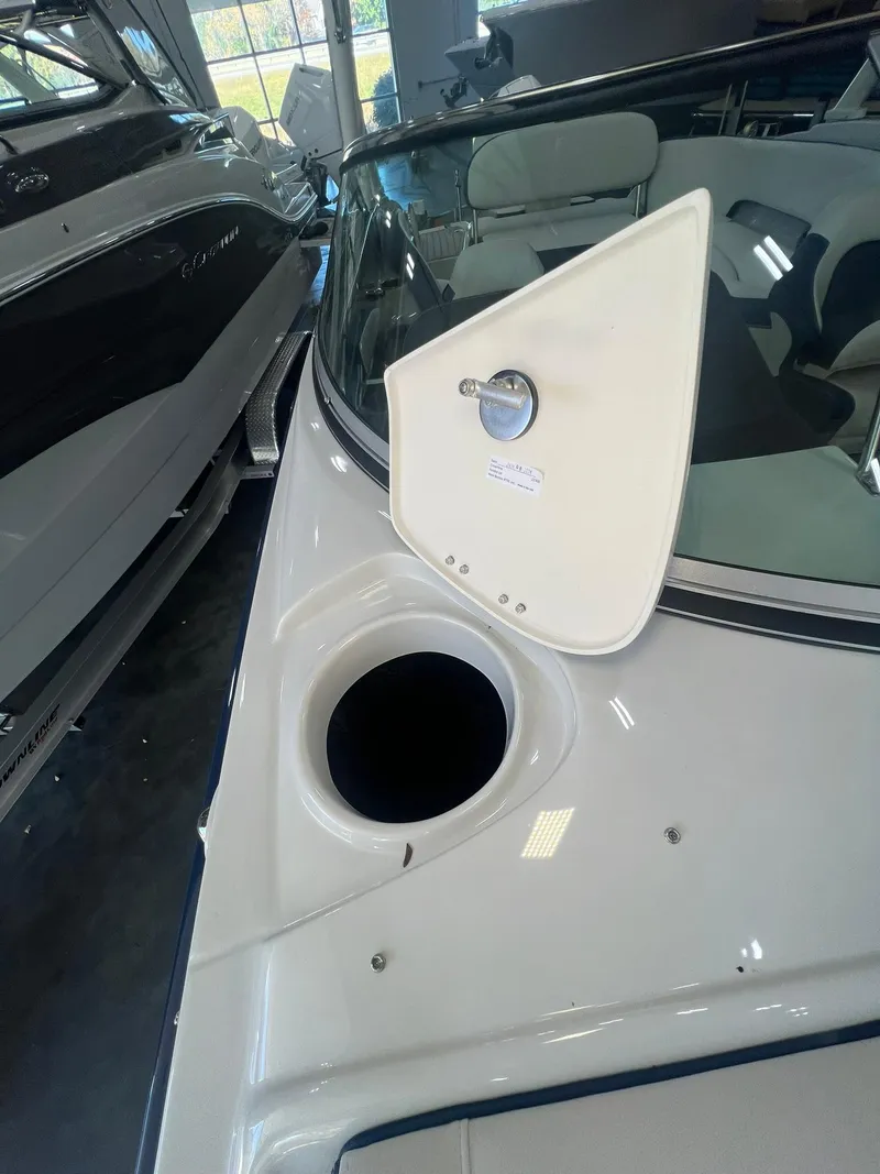 Slide: The Image of 2025 Crownline Eclipse E260 XS boat interior with open storage compartment. - 20