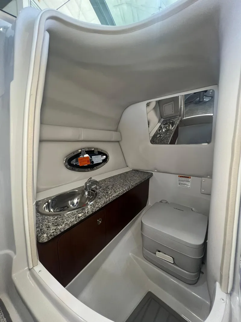 Slide: The Image of 2025 Crownline Eclipse E260 XS boat interior with sink and toilet. - 22