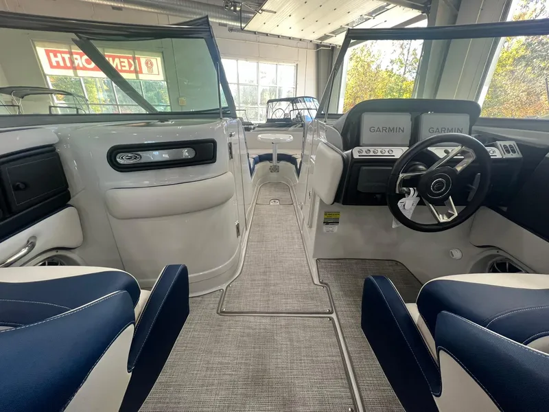 Slide: The Image of Interior of 2025 Crownline Eclipse E260 XS boat with modern dashboard and seating. - 25