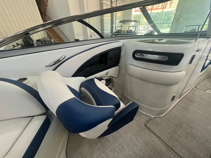 Slide: The Image of 2025 Crownline Eclipse E260 XS boat interior with blue and white seating. - 27
