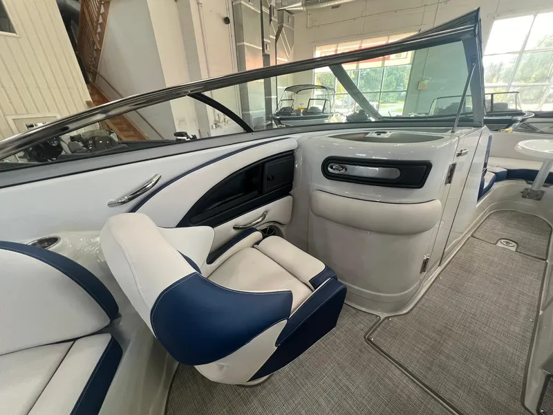 Slide: The Image of 2025 Crownline Eclipse E260 XS boat interior with blue and white seating. - 28