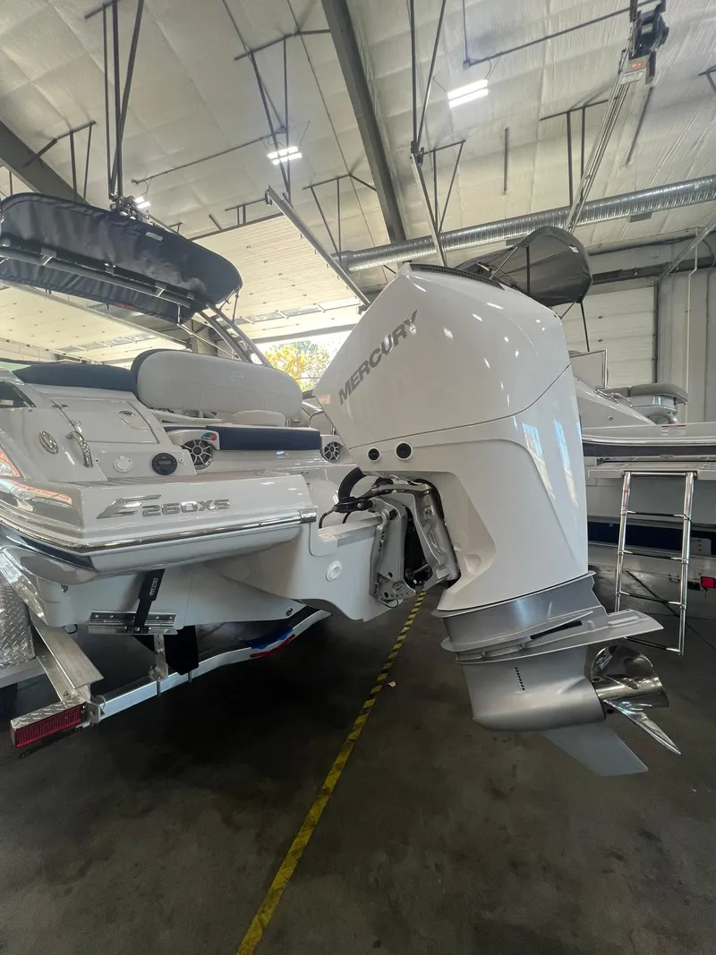 Slide: The Image of 2025 Crownline Eclipse E260 XS boat with Mercury outboard engine in a showroom. - 3