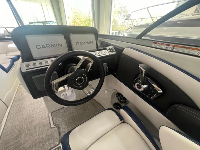 Slide: The Image of 2025 Crownline Eclipse E260 XS boat cockpit with Garmin displays and modern steering wheel. - 31