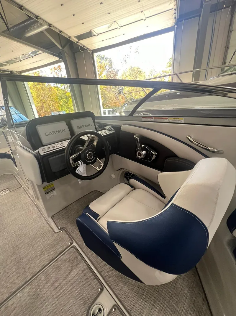 Slide: The Image of 2025 Crownline Eclipse E260 XS boat interior with modern steering and dashboard. - 32