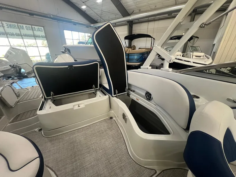 Slide: The Image of 2025 Crownline Eclipse E260 XS boat interior with open storage compartments. - 36