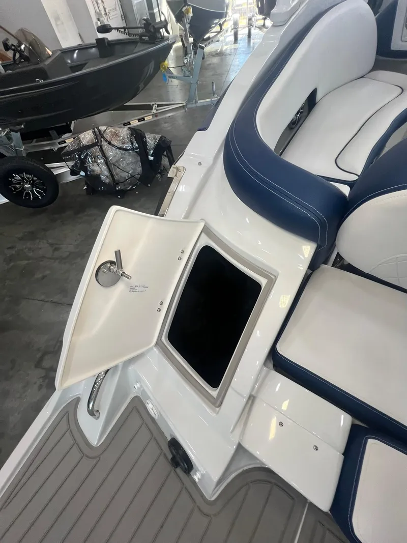 Slide: The Image of 2025 Crownline Eclipse E260 XS boat interior with open storage compartment. - 4