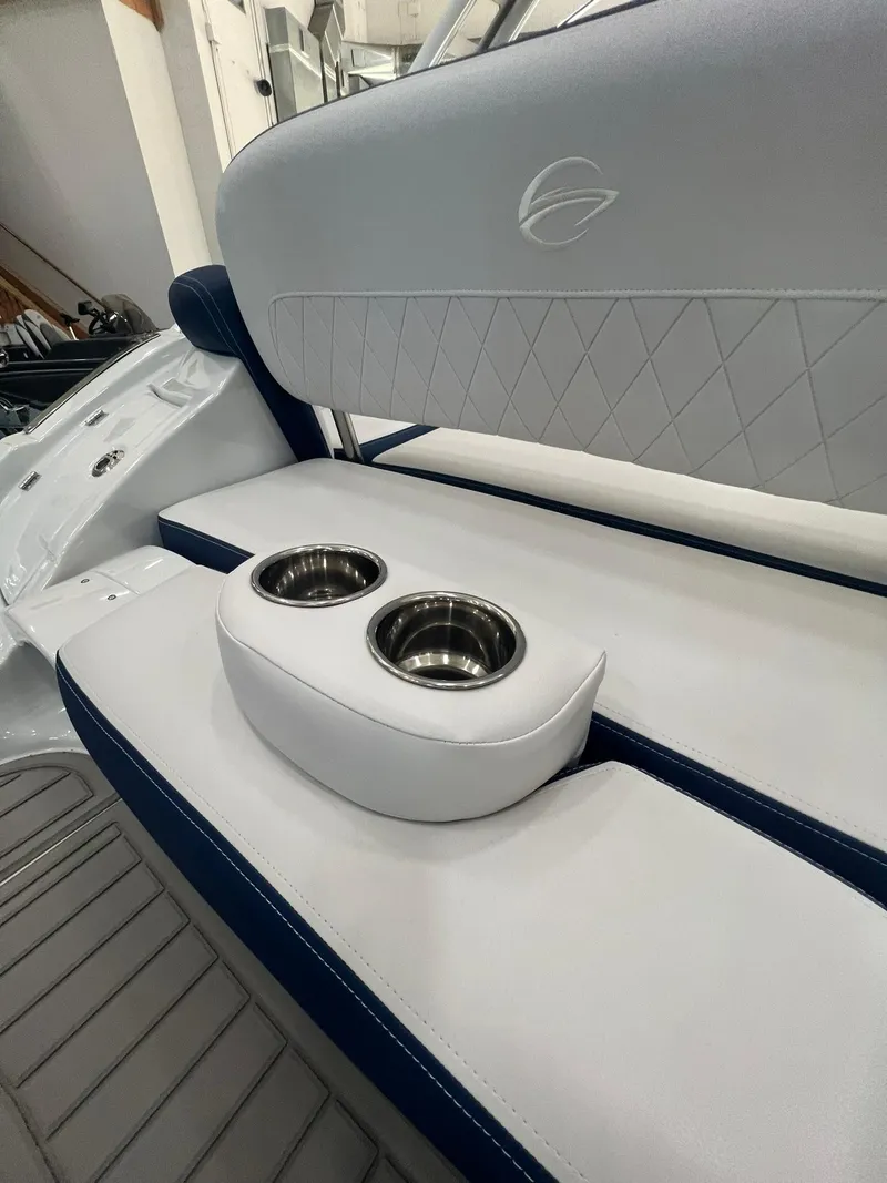 Slide: The Image of 2025 Crownline Eclipse E260 XS boat interior with cup holders and cushioned seating. - 40