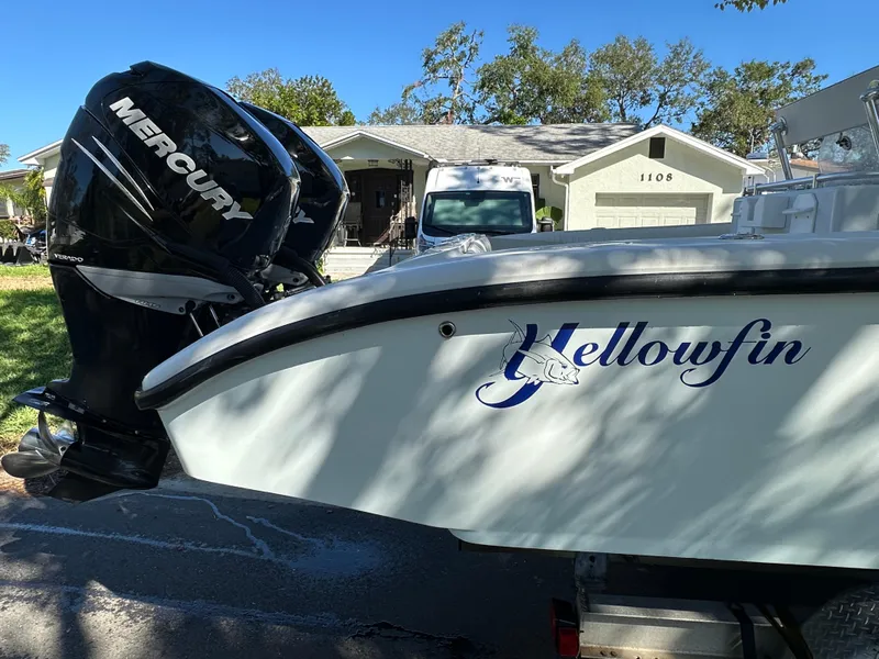Slide: The Image of 2001 Yellowfin 31 boat with Mercury outboard engine, parked in residential area. - 14