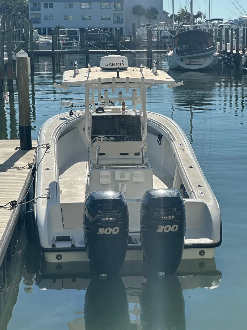 Slide: The Image of 2001 Yellowfin 31 boat with twin 300 horsepower engines docked in marina. - 2