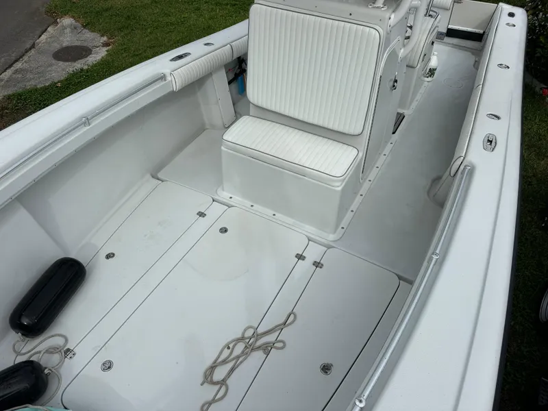 Slide: The Image of 2001 Yellowfin 31 boat interior with white seating and deck, featuring rope and fenders. - 22