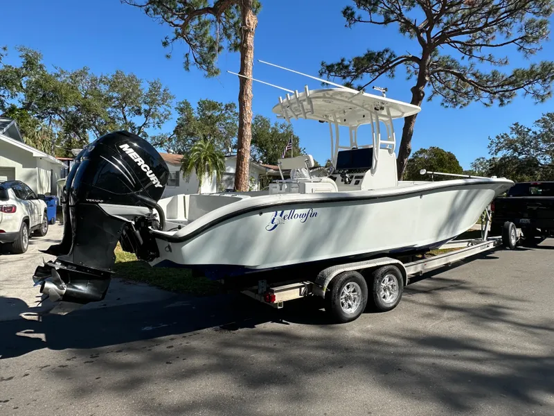 Slide: The Image of 2001 Yellowfin 31 boat on trailer with Mercury outboard, parked outdoors. - 27