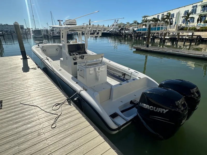 Slide: The Image of 2001 Yellowfin 31 boat docked with twin Mercury engines in a marina. - 3