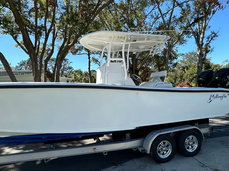 Slide: The Image of 2001 Yellowfin 31 boat on trailer, parked outdoors under trees. - 7
