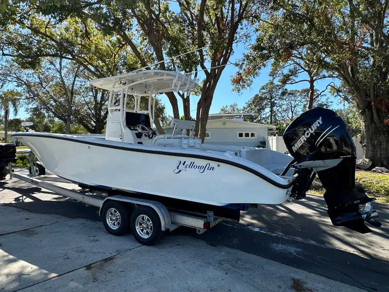 Slide: The Image of 2001 Yellowfin 31 boat on trailer with Mercury outboard, parked outdoors. - 9