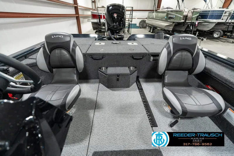Slide: The Image of 2025 Lund 1875 Pro-V Bass XS boat interior with two seats in a showroom. - 13