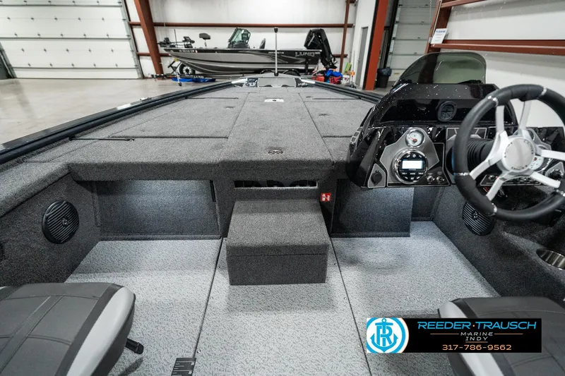 Slide: The Image of 2025 Lund 1875 Pro-V Bass XS boat interior with modern dashboard and seating. - 16