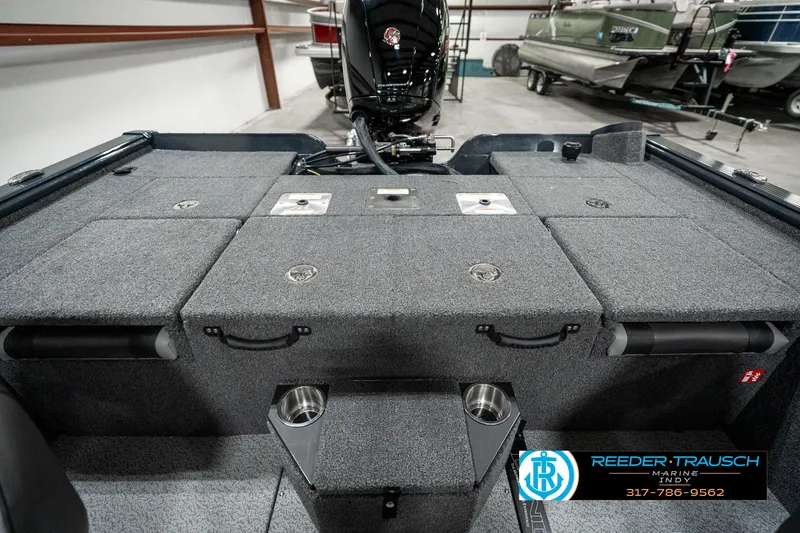 Slide: The Image of 2025 Lund 1875 Pro-V Bass XS boat interior with storage compartments and motor. - 21